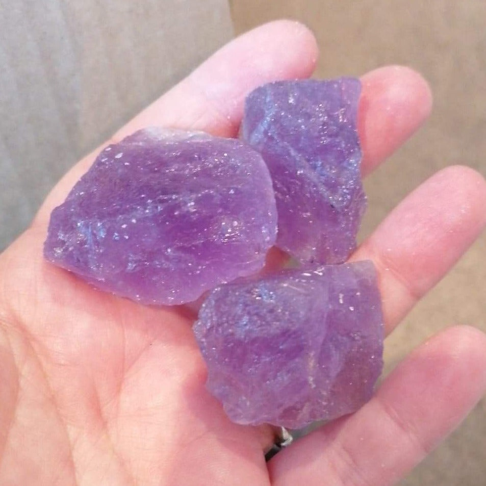 three pieces of raw purple amethyst chunks