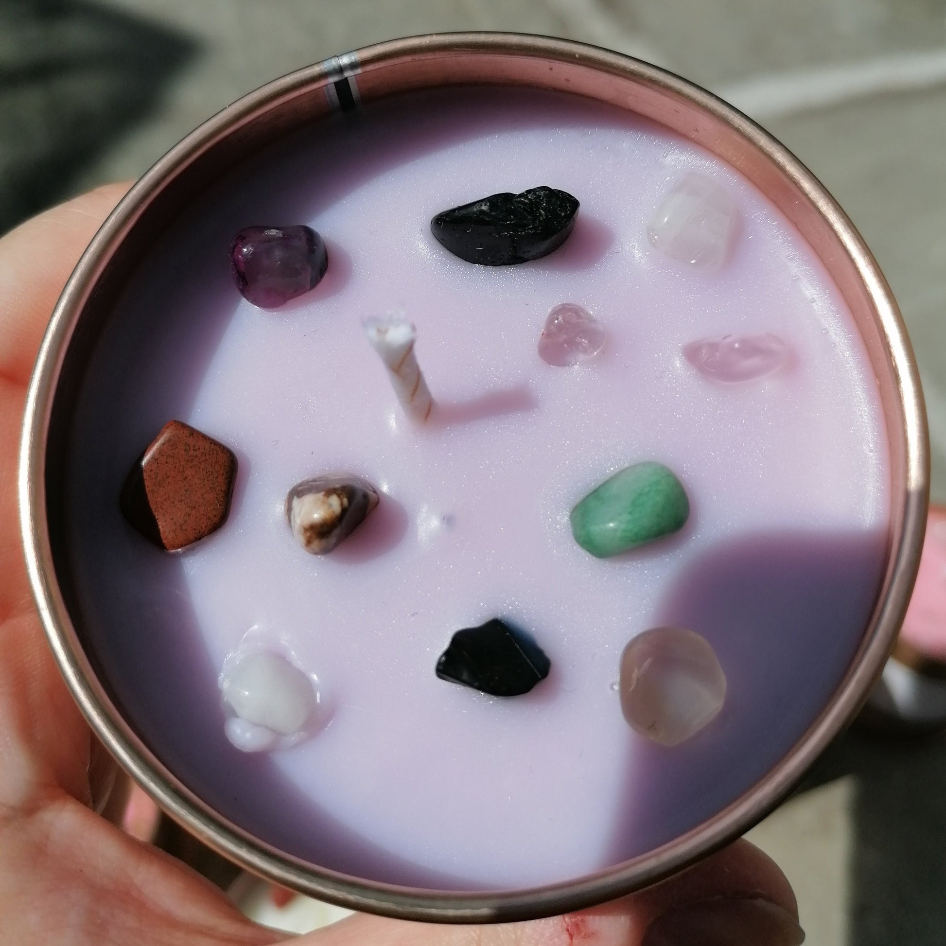 purple candle in a rose gold tin decorated with mixed colour crystal chips