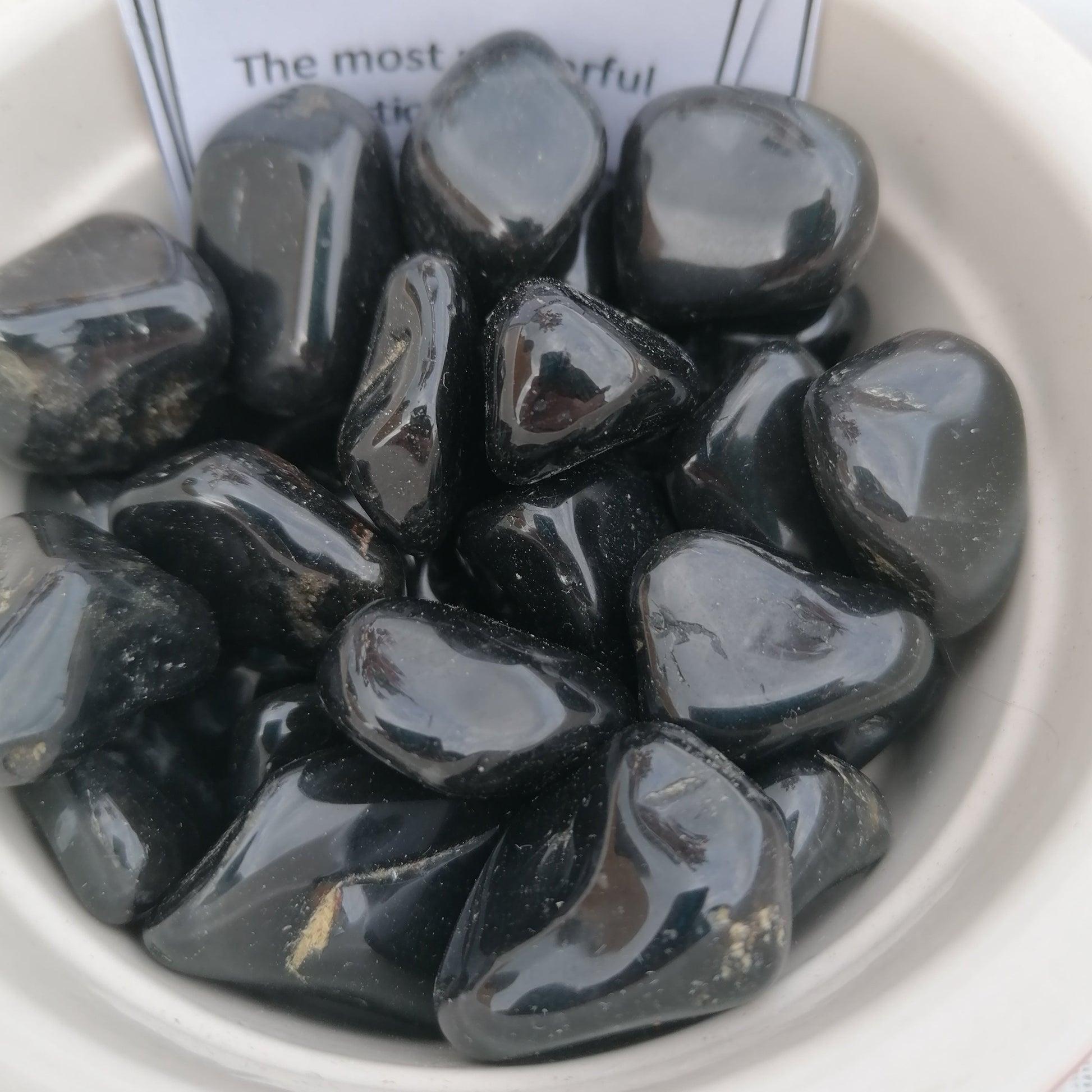 a dish of black onyx tumblestones