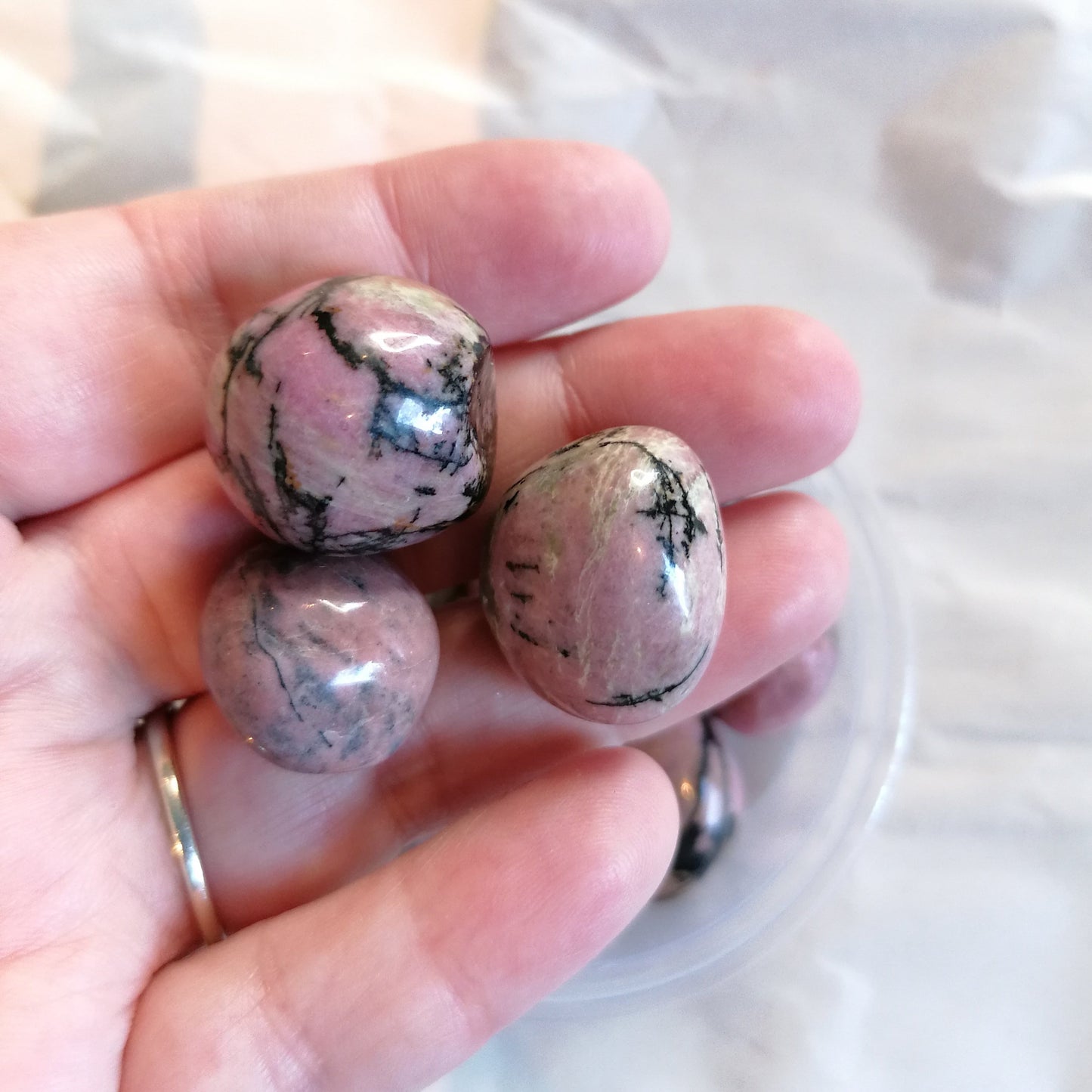 Pink and black rhodonite tumbles