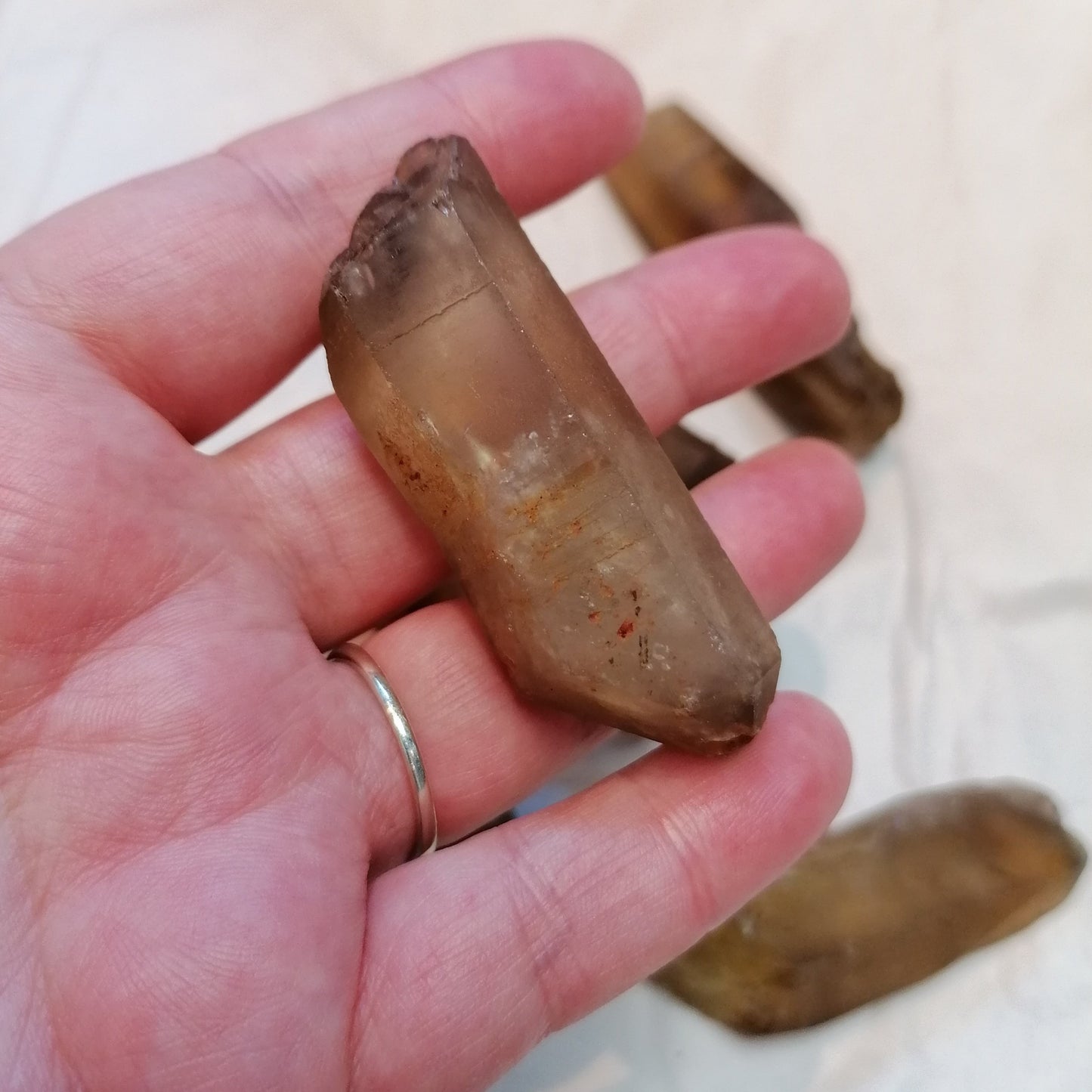 a natural raw dark amber citrine crystal point