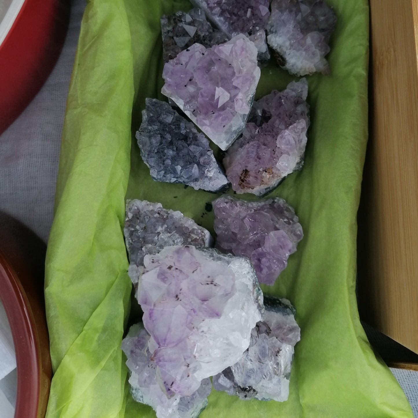 small purple amethyst cluster crystals on a tray