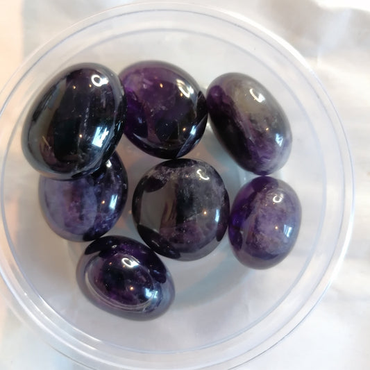 a round dish of purple amethyst tumblestones