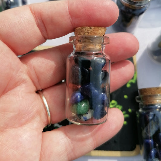 blue and mixed colour sodalite crystal chips in a small bottle