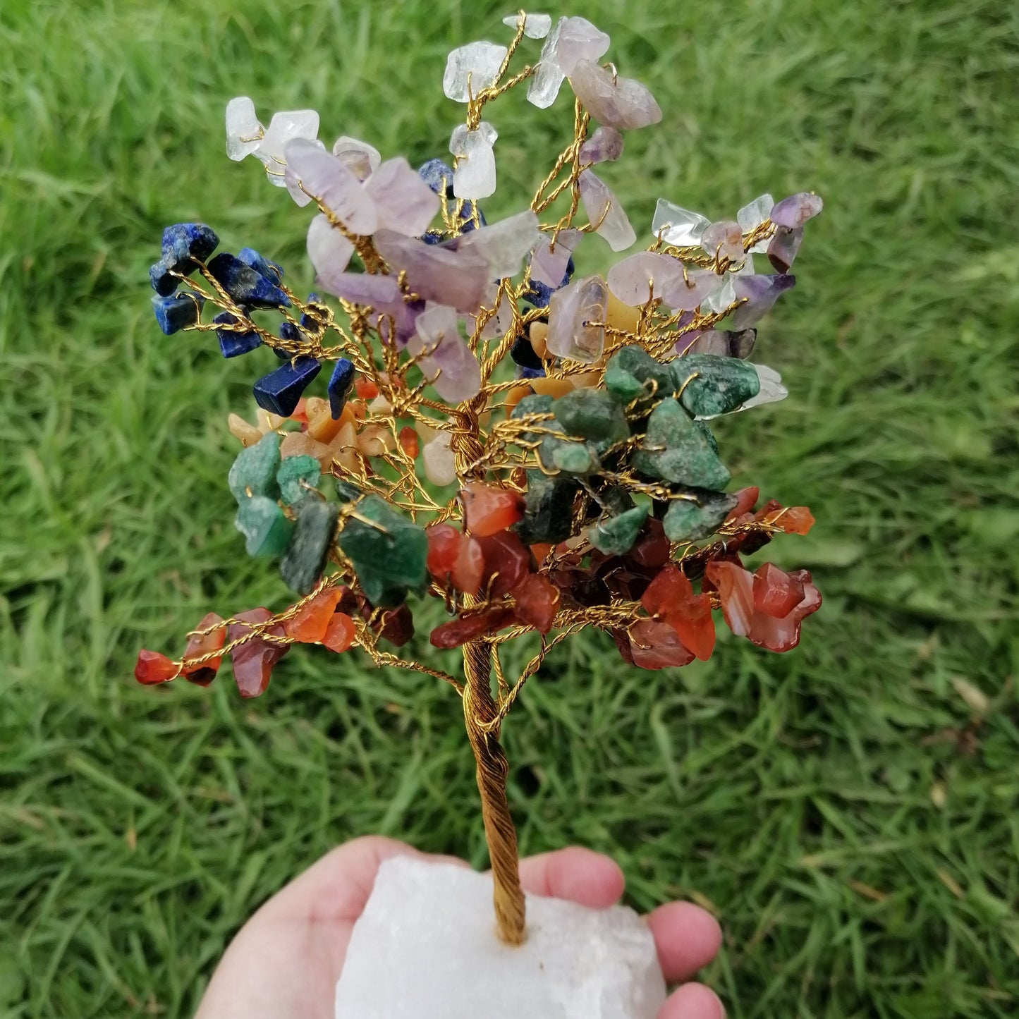 a large wire tree with mixed colour chakra crystal chips with a milky quartz base