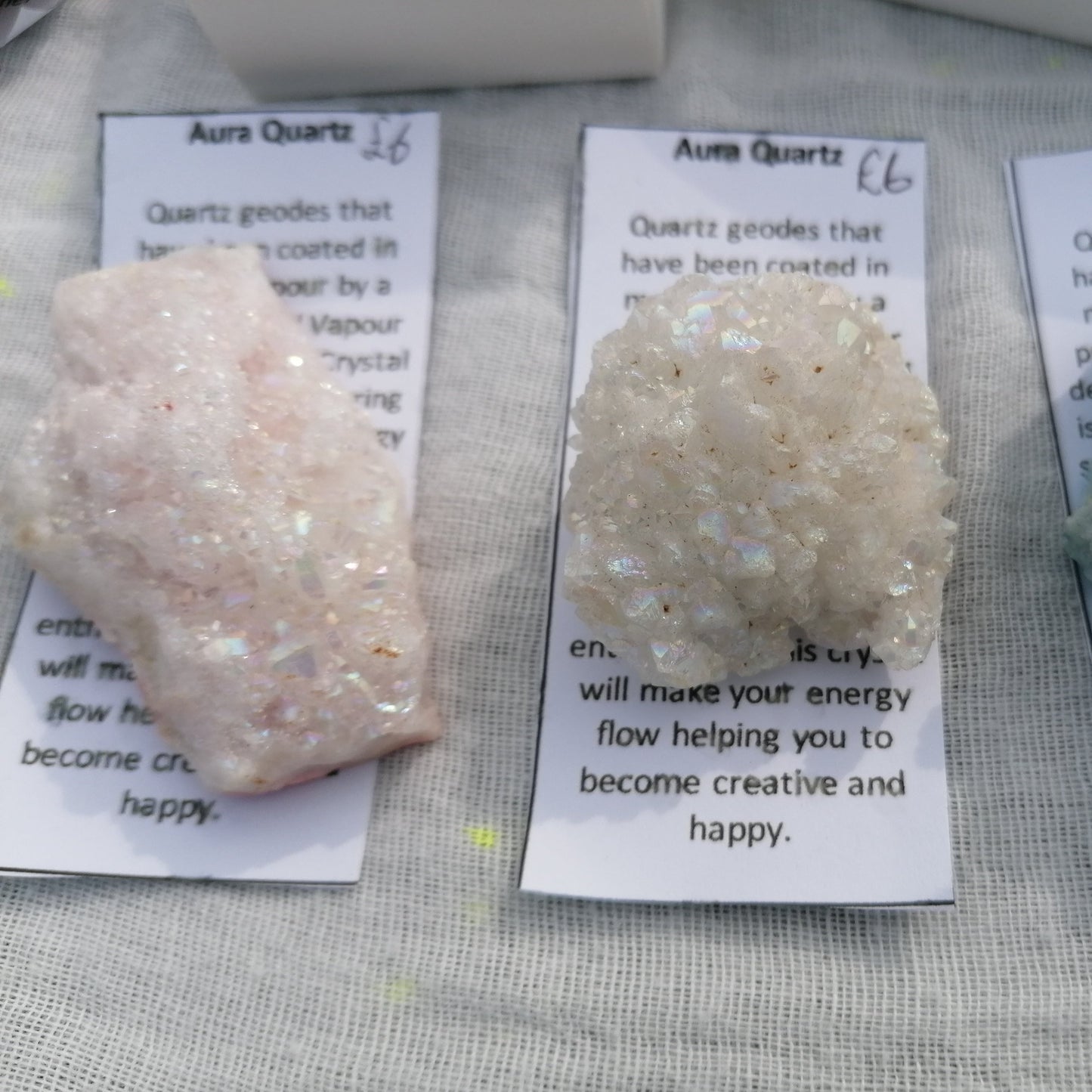 a pink and a white aura druzy with description card