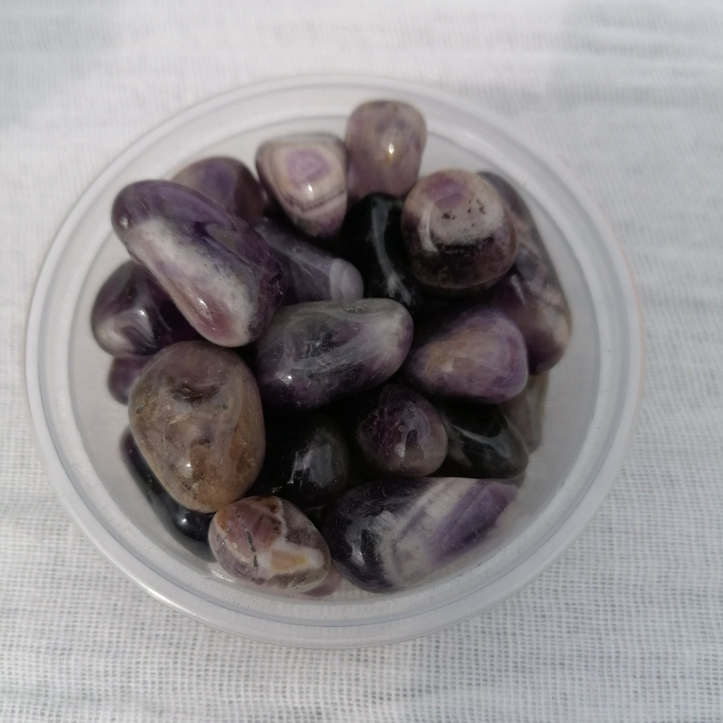 three small dark purple amethyst tumblestones