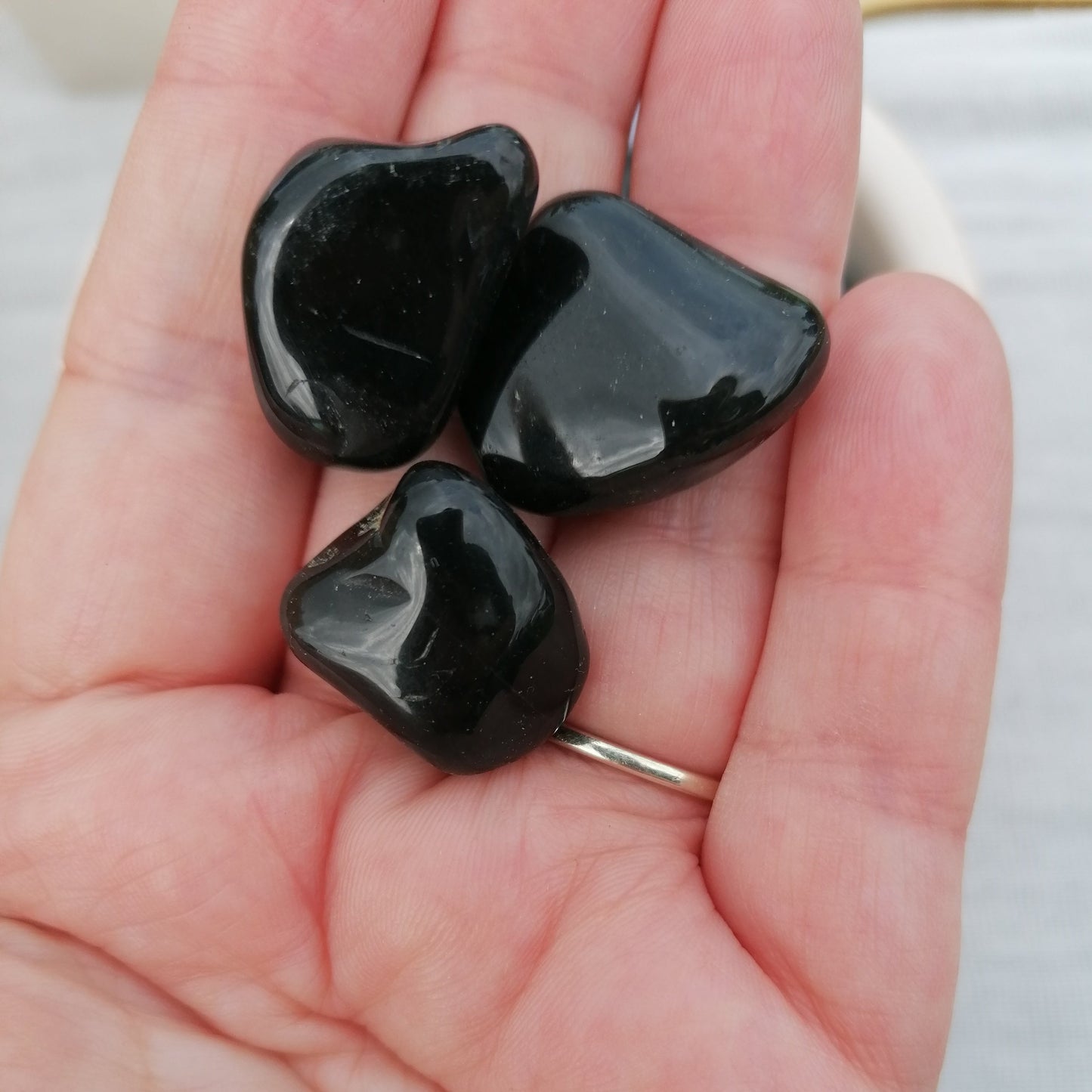 three black onyx tumblestones