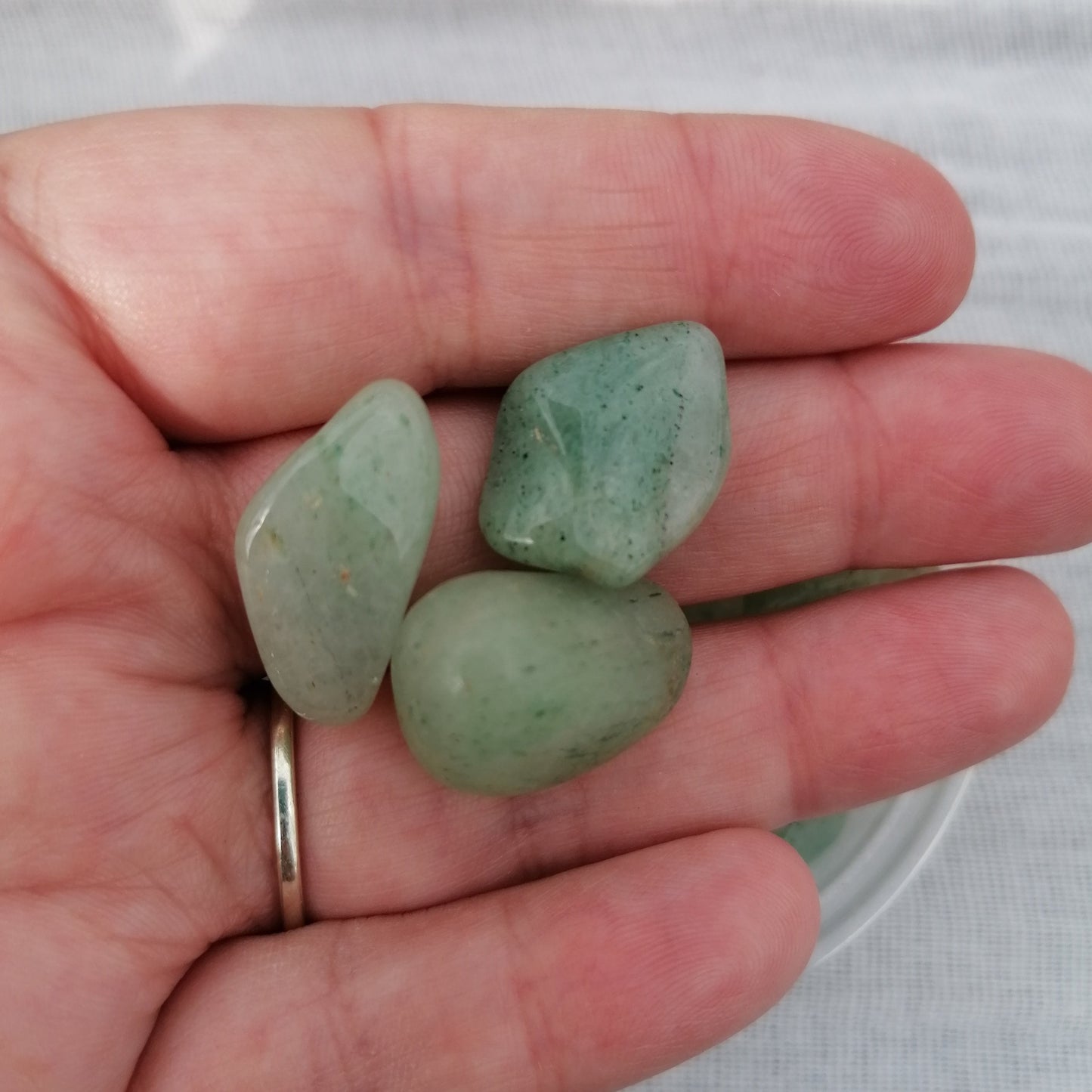 three pieces of light green aventurine small tumblestones