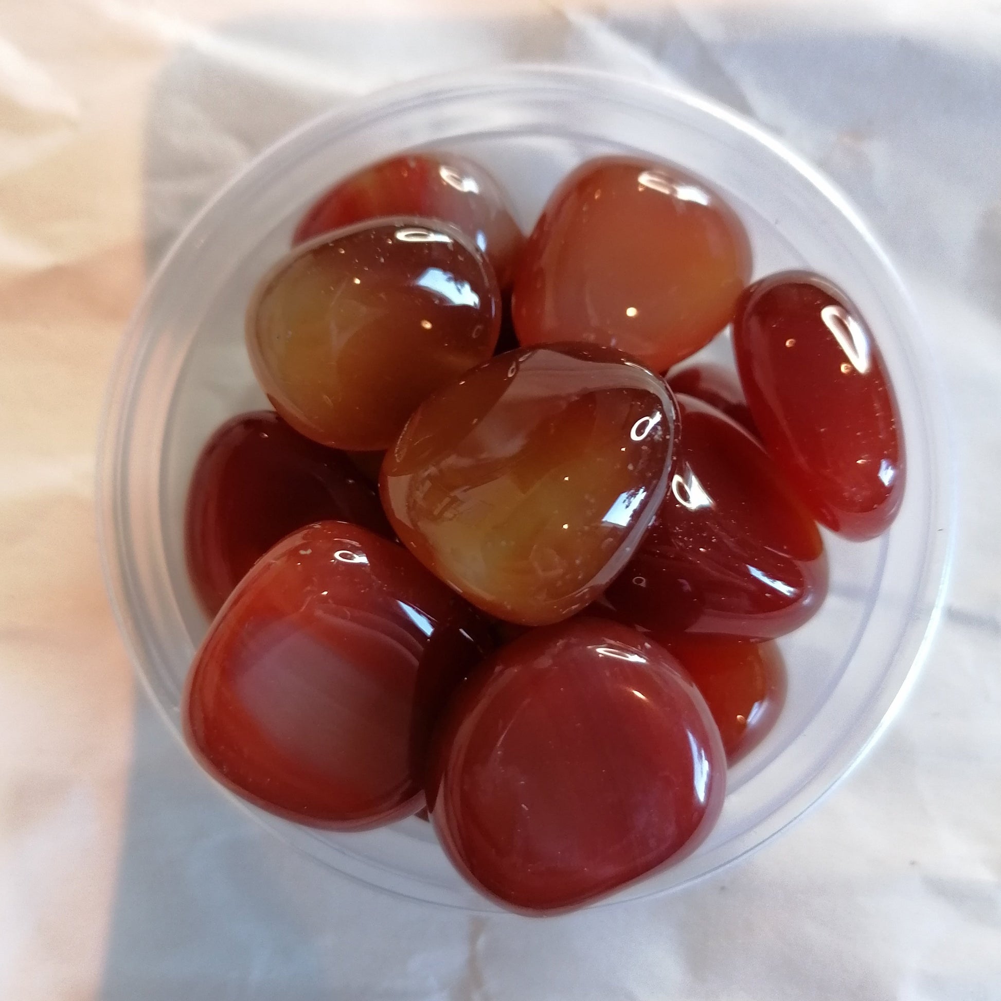 a dish of red carnelian crystal tumblestones