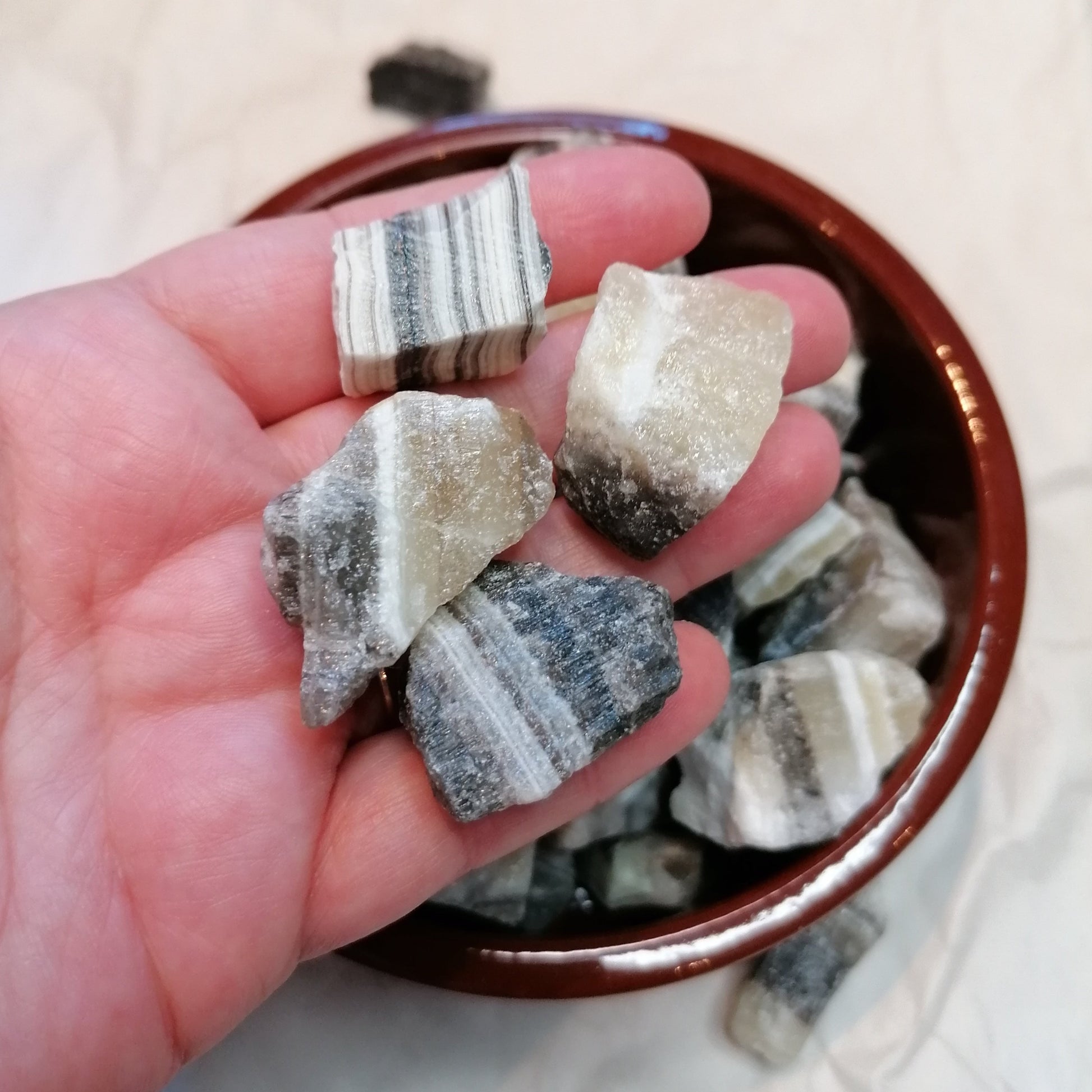 Yellow white and black banded raw zebra calcite chunk