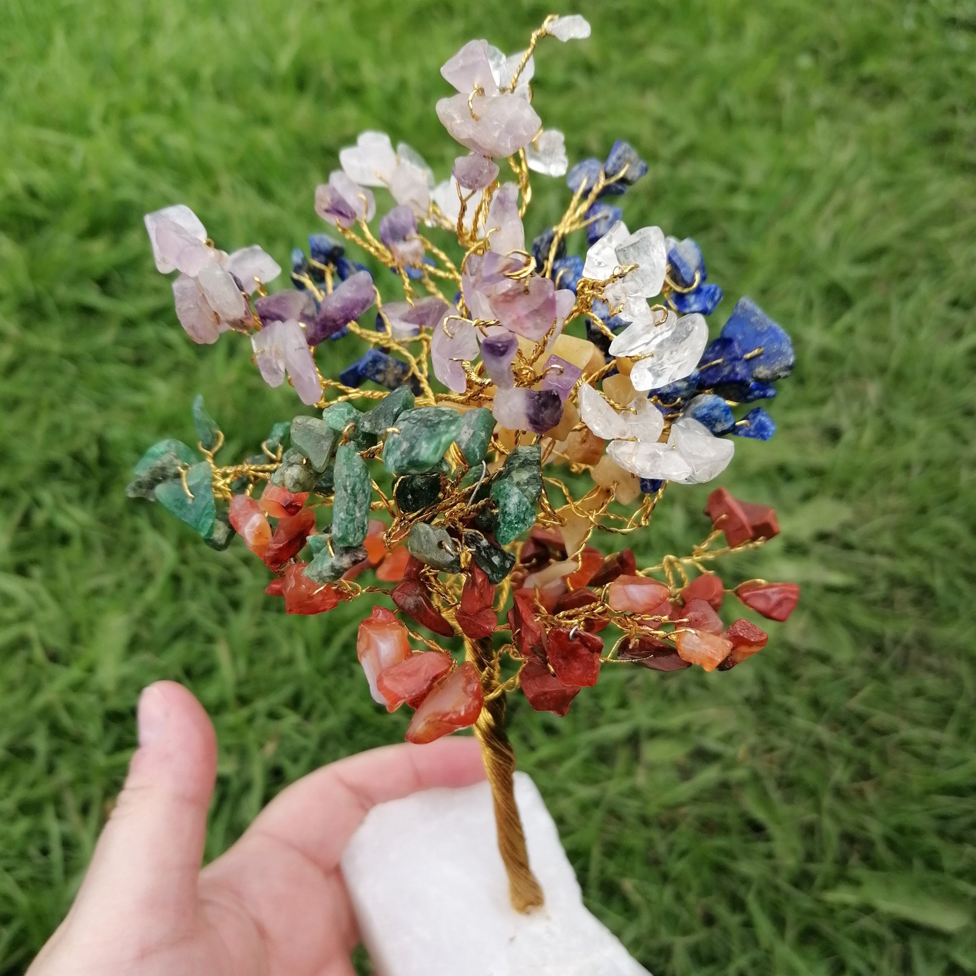 a wire tree with mixed colour chakra crystal chips with a milky quartz base