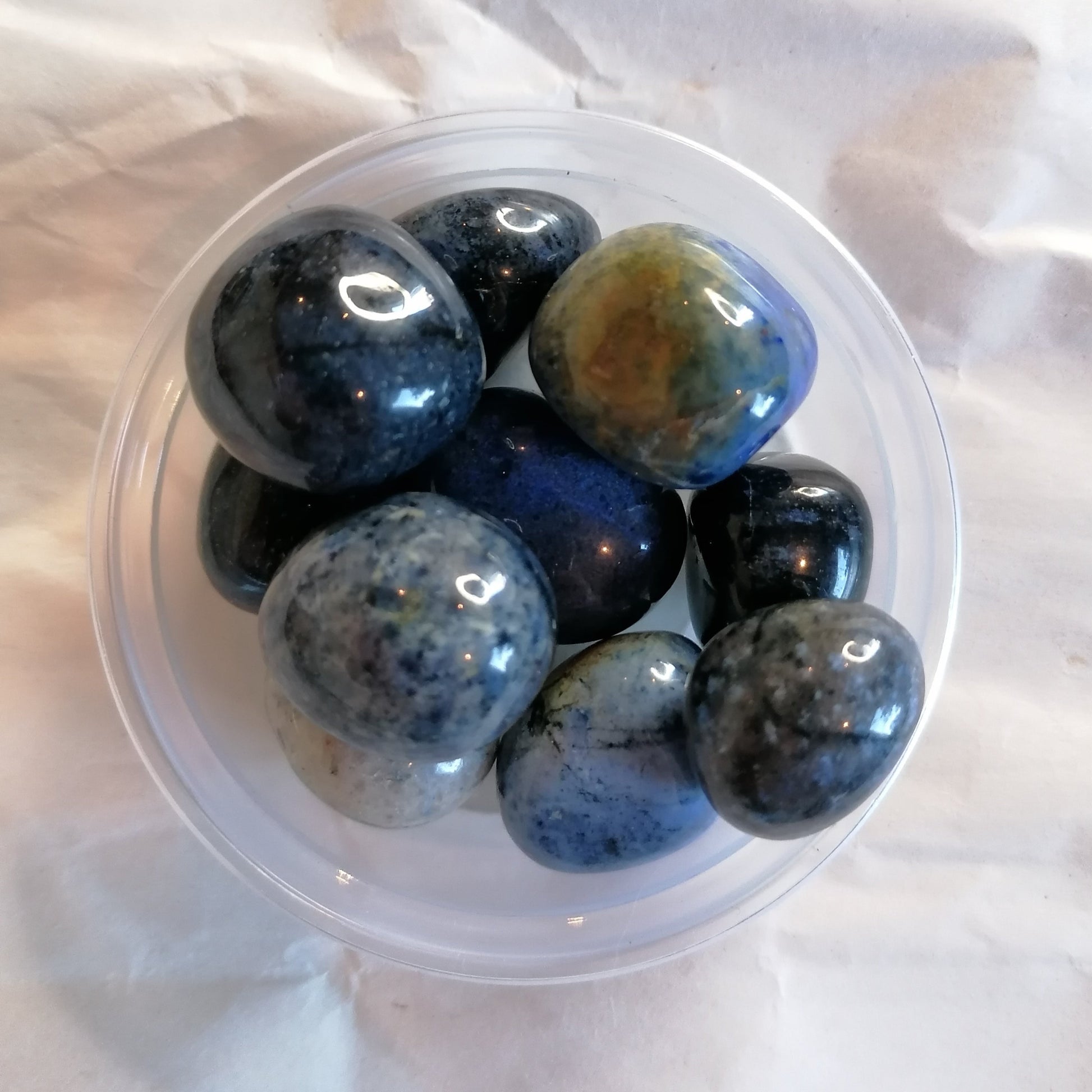 a dish of blue Dumortierite tumblestones