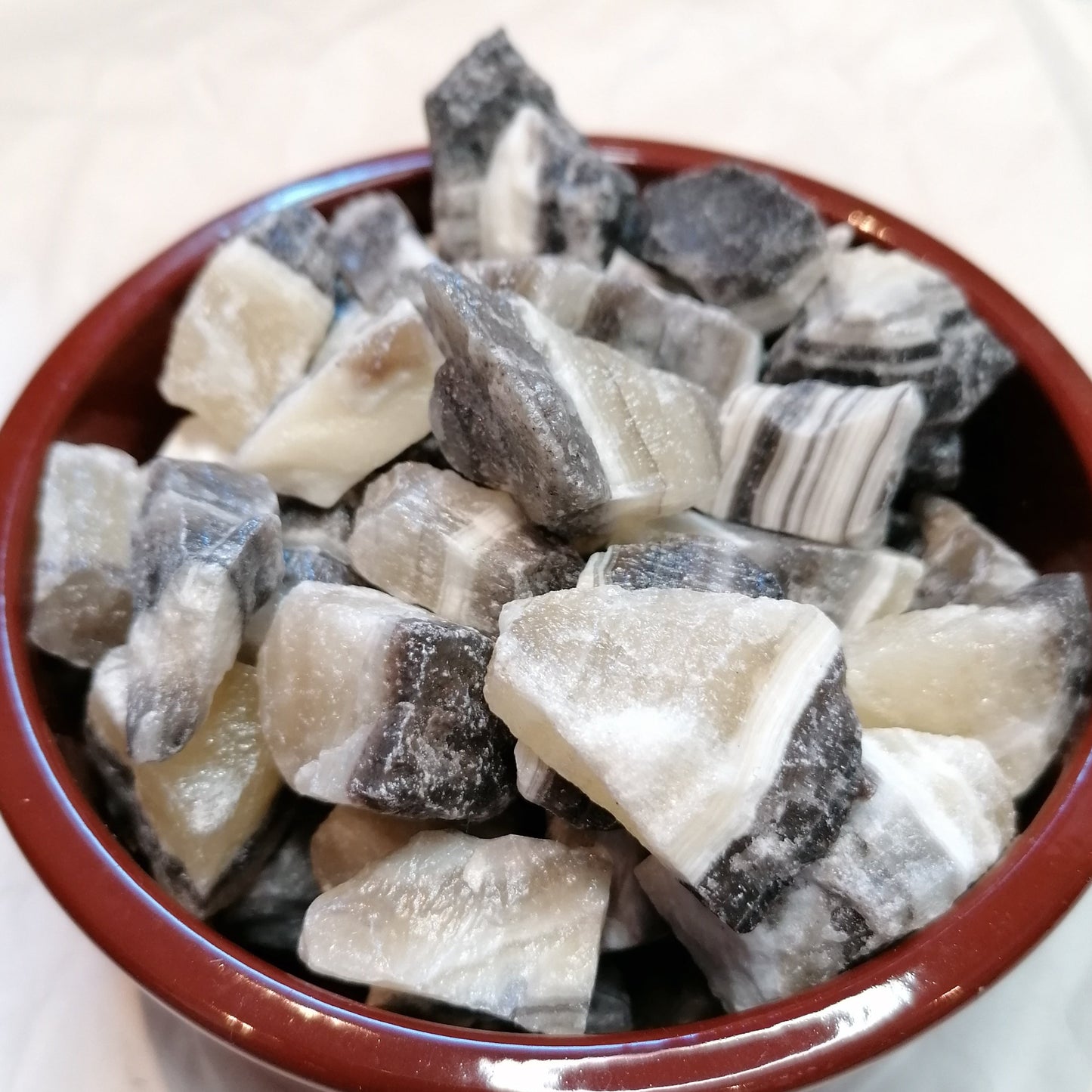 Yellow white and black banded raw zebra calcite chunk